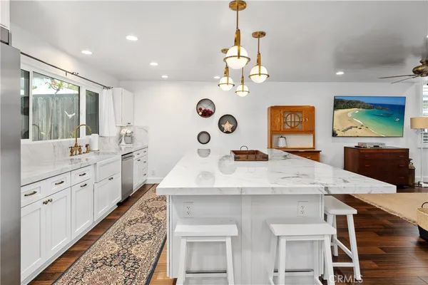 a kitchen with granite countertop a stove and a refrigerator