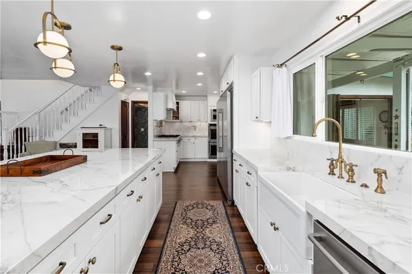 a kitchen with stainless steel appliances granite countertop a refrigerator and cabinets
