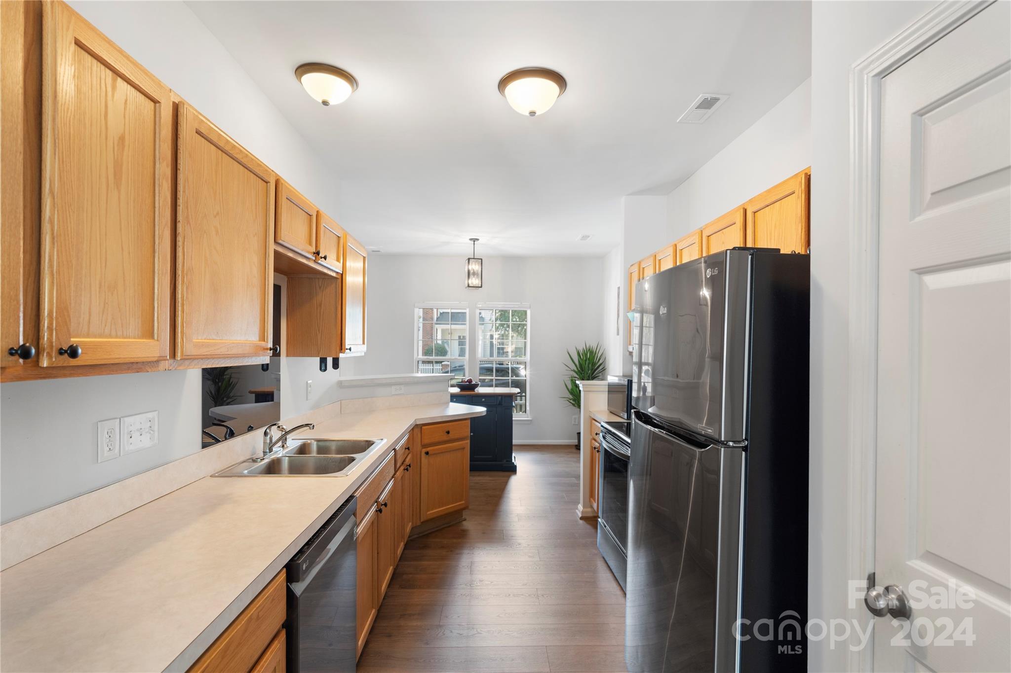 621 Atherton Way Rock Hill, SC 29730 - Photo 12 of 33 a kitchen with stainless steel appliances a refrigerator sink and white cabinets
