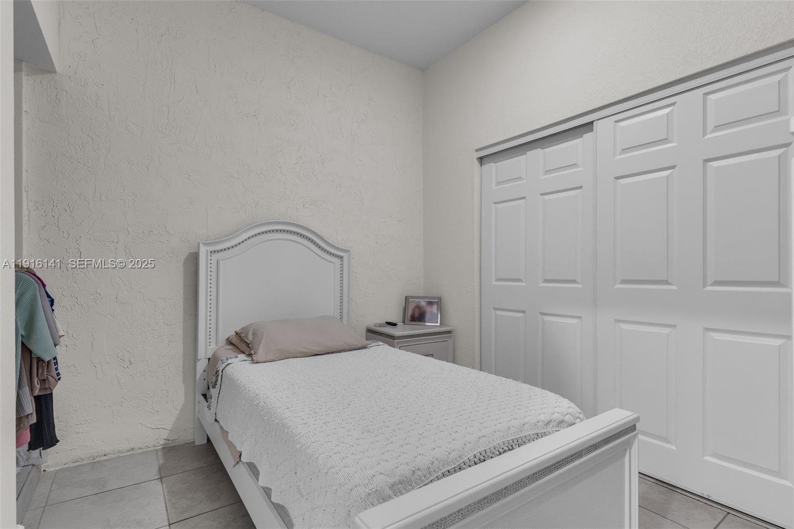 11413 Southwest 252nd Terrace Homestead, FL 33032 - Photo 16 of 40 a bedroom with a bed and a refrigerator