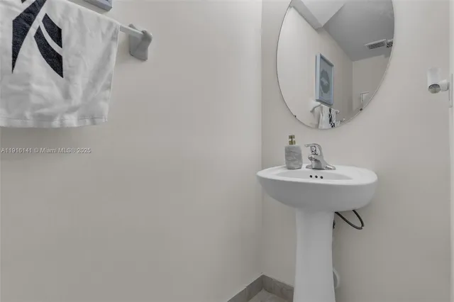 a bathroom with a sink a mirror and vanity