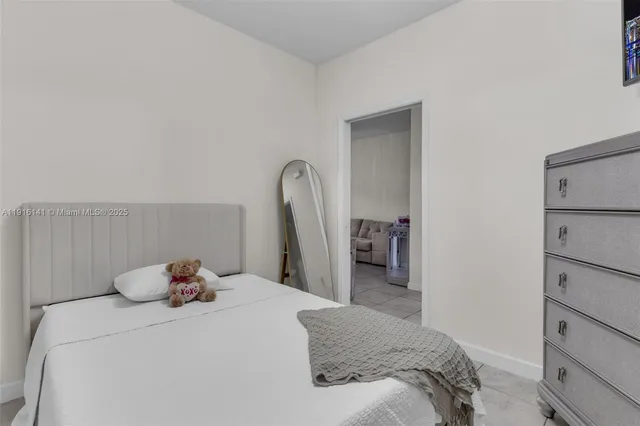 a bedroom with a bed and a large mirror