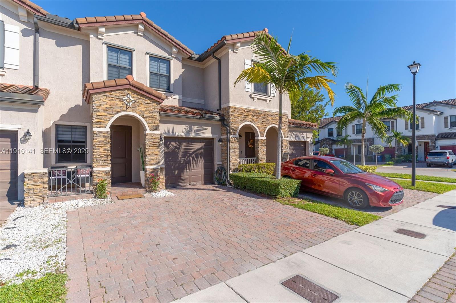 11413 Southwest 252nd Terrace Homestead, FL 33032 - Photo 2 of 40 a front view of multiple houses with yard