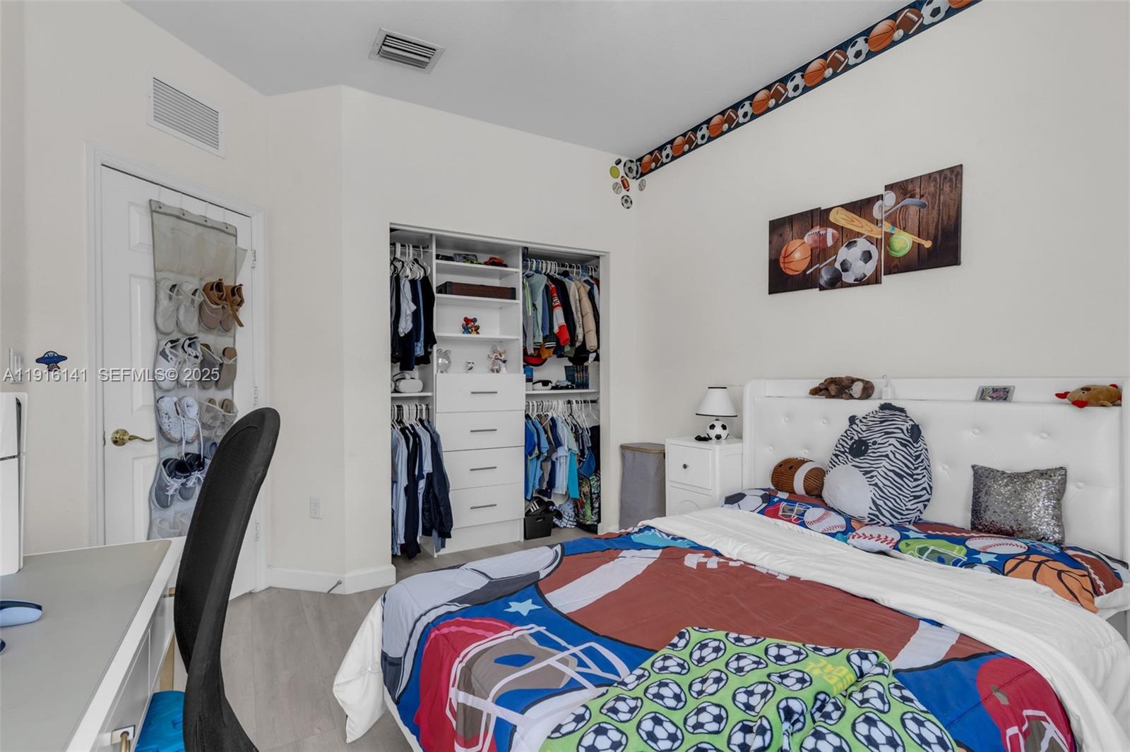 11413 Southwest 252nd Terrace Homestead, FL 33032 - Photo 22 of 40 a bedroom with a bed a desk and chair