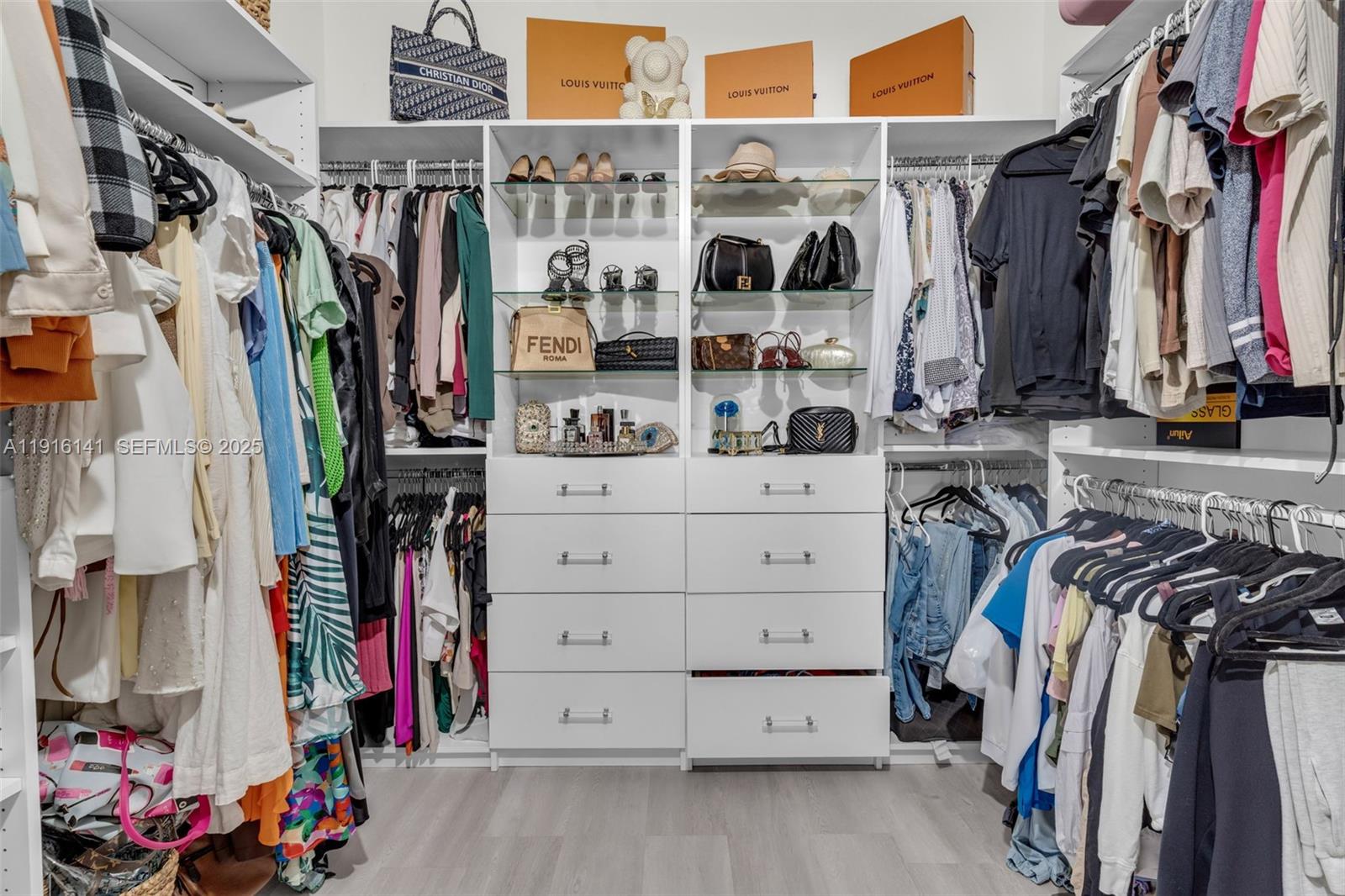 11413 Southwest 252nd Terrace Homestead, FL 33032 - Photo 24 of 40 a view of walk in closet with clothes and shoes