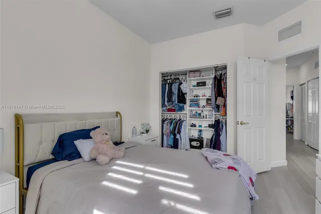 a bedroom with a bed and closet