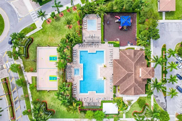 an aerial view of residential houses with outdoor space and swimming pool