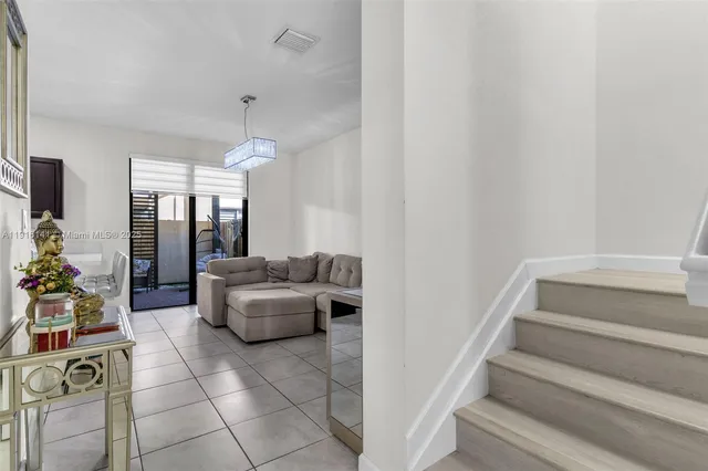 a living room with furniture and a chandelier