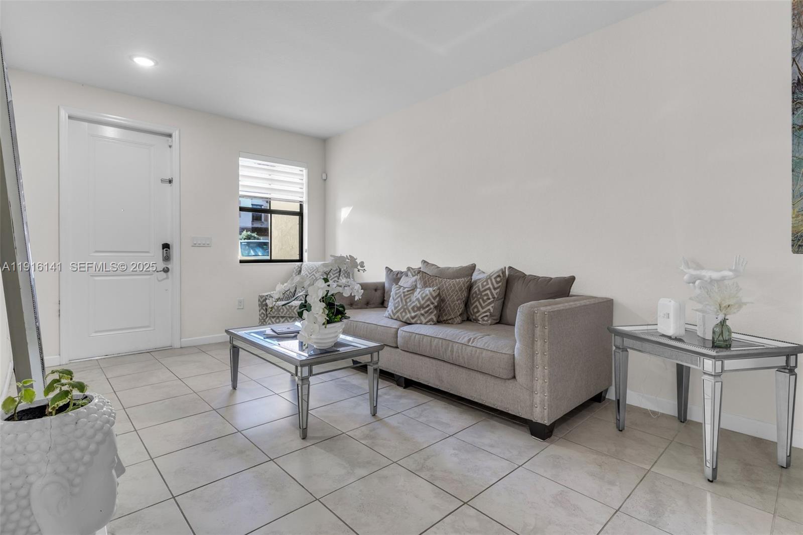 11413 Southwest 252nd Terrace Homestead, FL 33032 - Photo 9 of 40 a living room with furniture and a potted plant