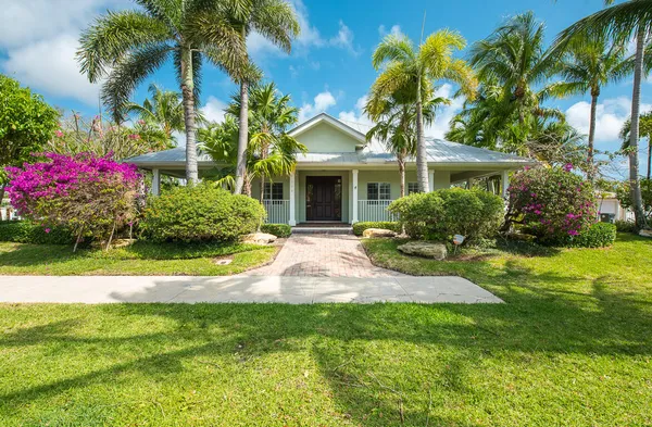 a front view of house with yard and swimming pool
