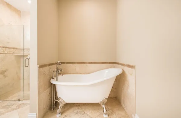 a white bath tub sitting in a bathroom