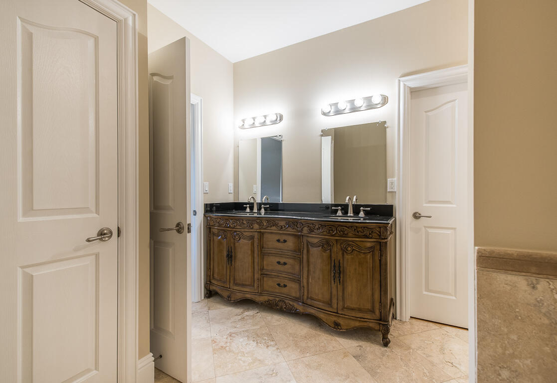 199 Northwest 7th Street Boca Raton, FL 33432 - Photo 17 of 37 a bathroom with a double vanity sink and mirror