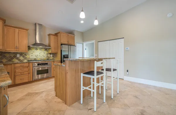 a kitchen with granite countertop cabinets and stainless steel appliances