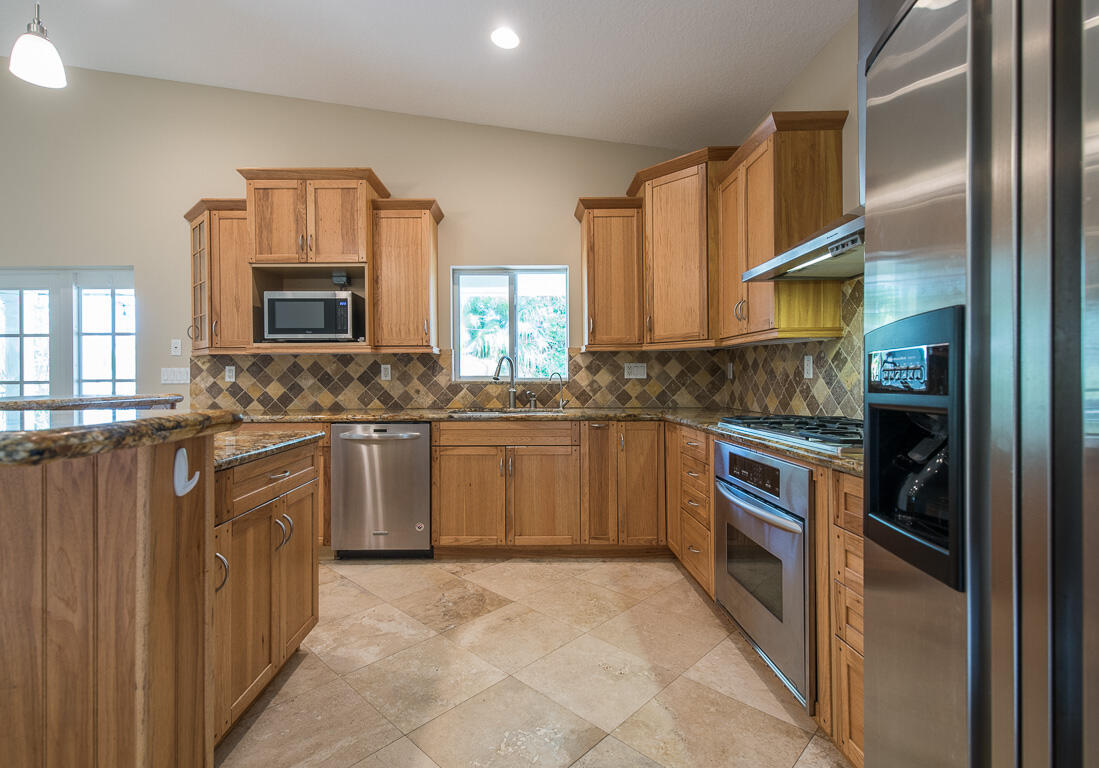199 Northwest 7th Street Boca Raton, FL 33432 - Photo 10 of 37 a kitchen with a sink stove and microwave