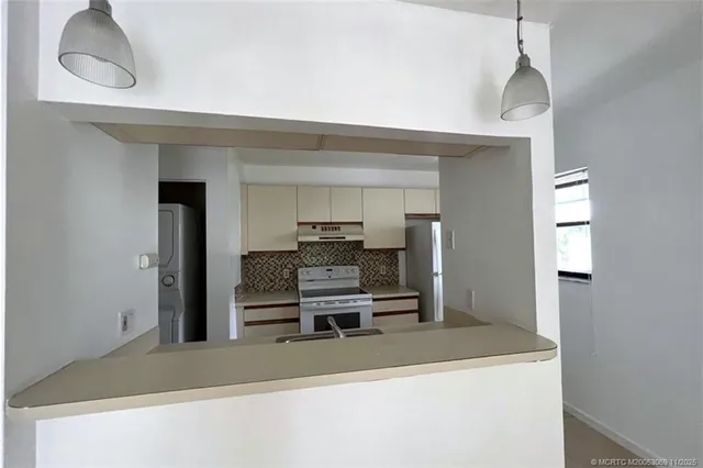 a dining room with furniture and a chandelier