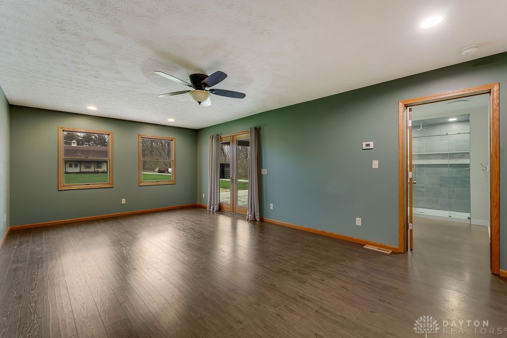 7400 Cook-Jones Road Waynesville, OH 45068 - Photo 27 of 72 This expansive room offers seamless indoor-outdoor living with elegant French doors and durable wood flooring.