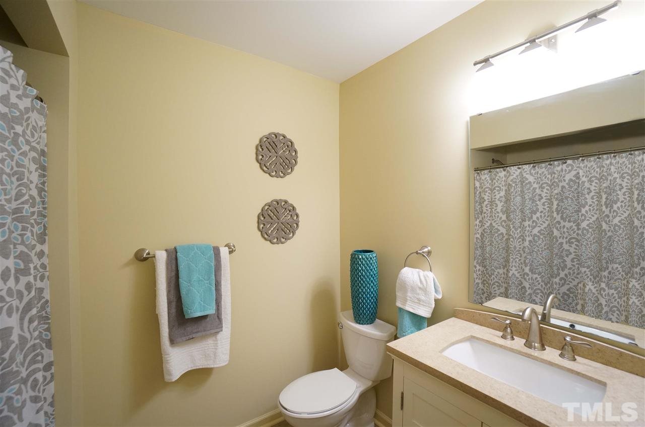 3413 Gemini Drive Raleigh, NC 27604 - Photo 9 of 16 a bathroom with a sink mirror vanity and toilet