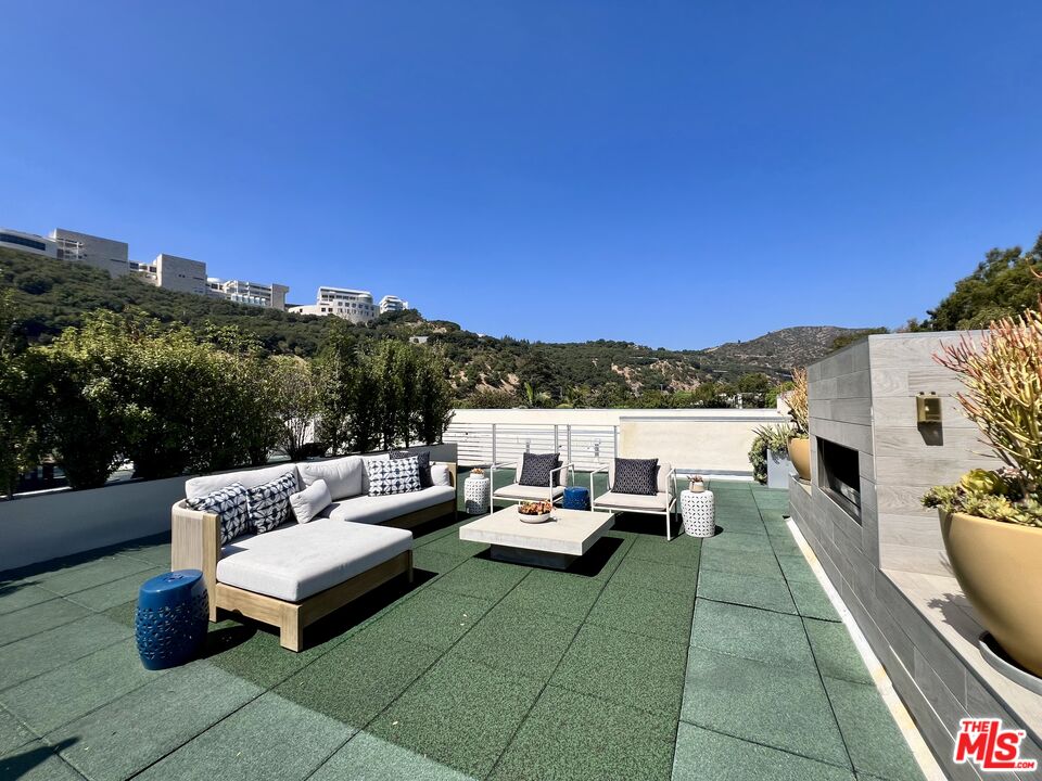 11715 Bellagio Road, Unit 204 Los Angeles, CA 90049 - Photo 21 of 27 a roof deck with couches and potted plants