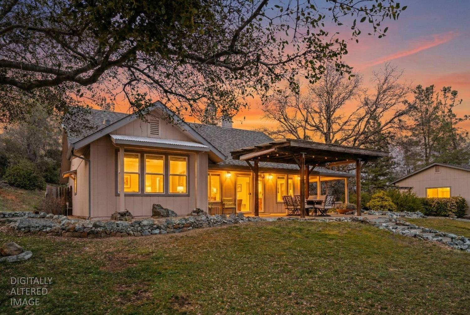 15666 Wolf Mountain Road Grass Valley, CA 95949 - Photo 1 of 78 a front view of a house with a yard