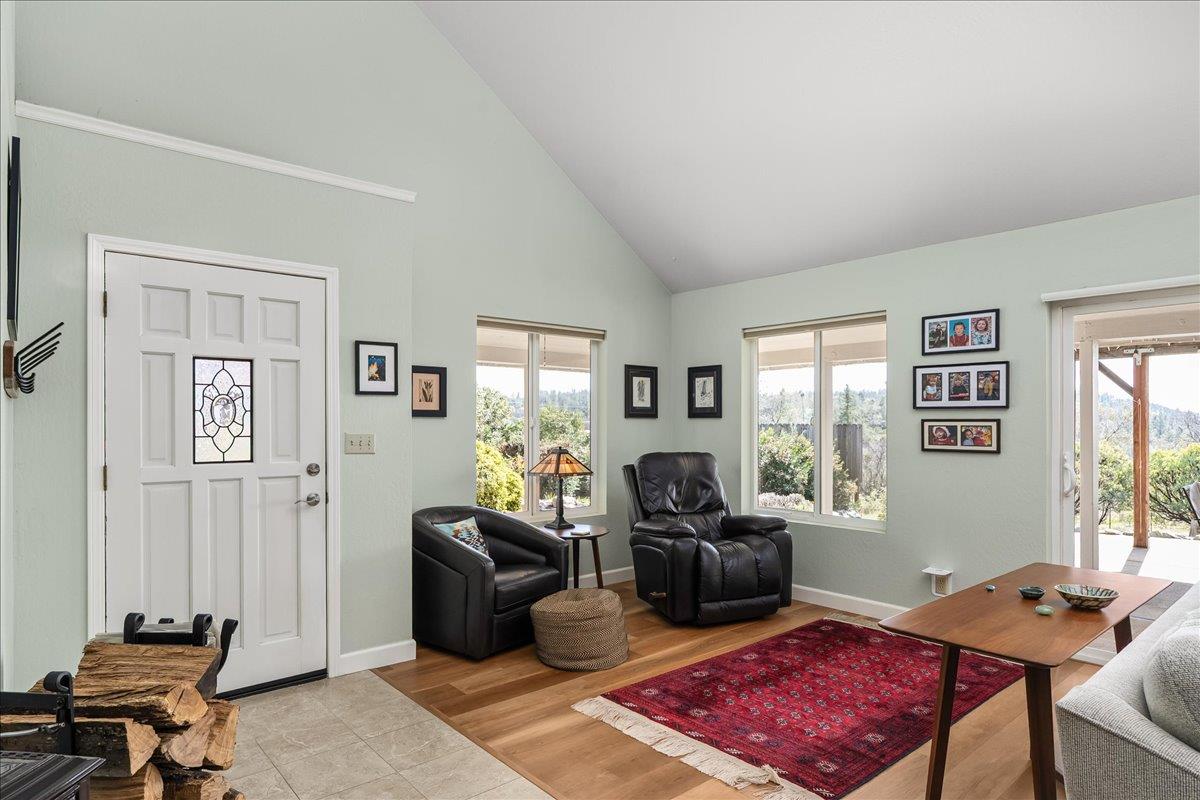 15666 Wolf Mountain Road Grass Valley, CA 95949 - Photo 12 of 78 a living room with furniture a flat screen tv and a window