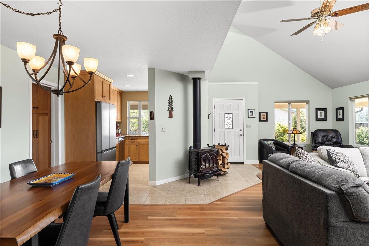 15666 Wolf Mountain Road Grass Valley, CA 95949 - Photo 13 of 78 a living room with furniture a dining table and chairs with wooden floor