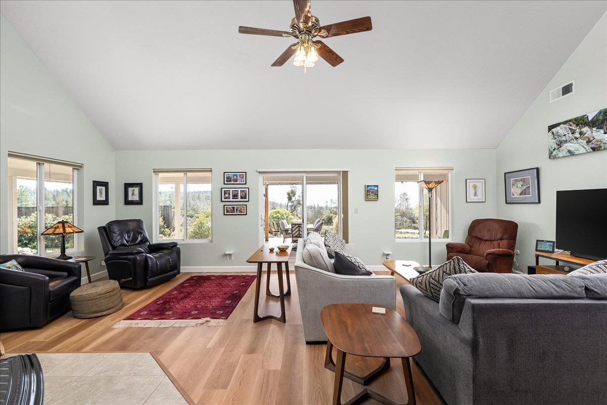 15666 Wolf Mountain Road Grass Valley, CA 95949 - Photo 16 of 78 a living room with furniture a flat screen tv and a large window