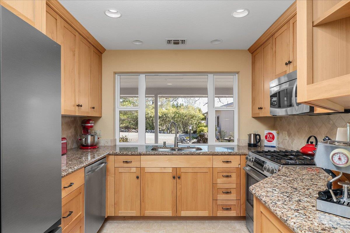 15666 Wolf Mountain Road Grass Valley, CA 95949 - Photo 17 of 78 a kitchen with stainless steel appliances granite countertop a sink stove and cabinets