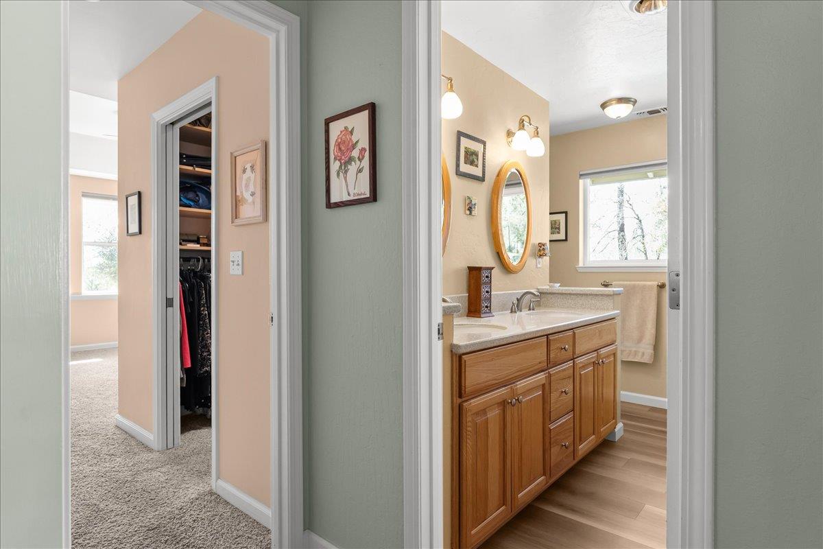15666 Wolf Mountain Road Grass Valley, CA 95949 - Photo 25 of 78 a bathroom with a sink a mirror and a window