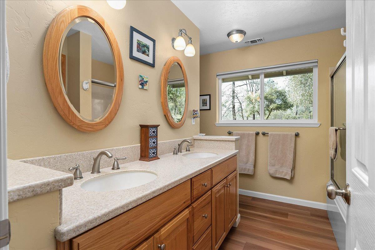 15666 Wolf Mountain Road Grass Valley, CA 95949 - Photo 26 of 78 a bathroom with 2 sink and a mirror