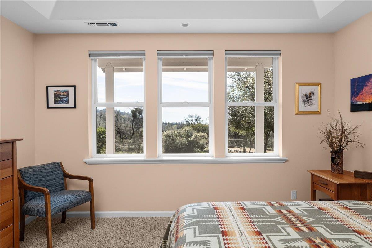 15666 Wolf Mountain Road Grass Valley, CA 95949 - Photo 29 of 78 a bedroom with a bed and a chair