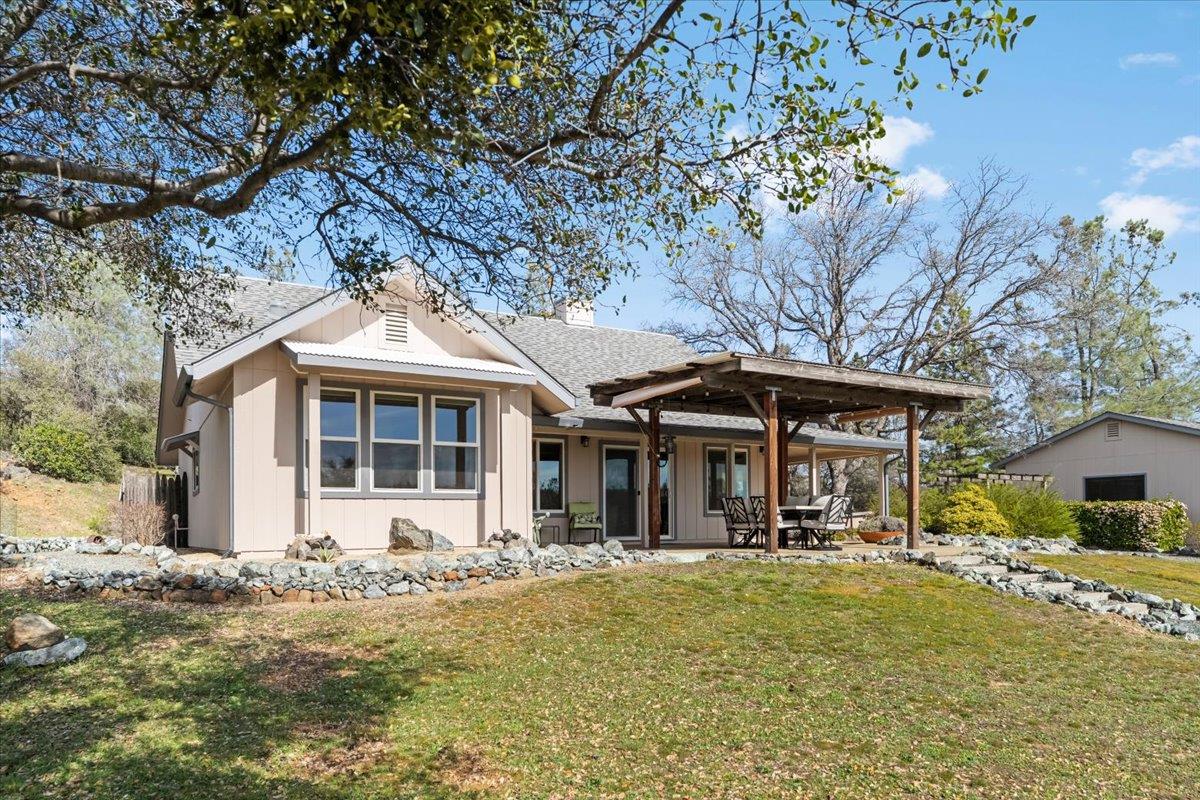 15666 Wolf Mountain Road Grass Valley, CA 95949 - Photo 33 of 78 a front view of a house with a yard