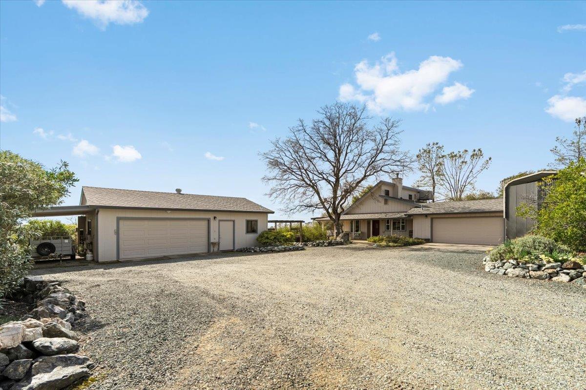 15666 Wolf Mountain Road Grass Valley, CA 95949 - Photo 41 of 78 a view of a house with a yard and garage