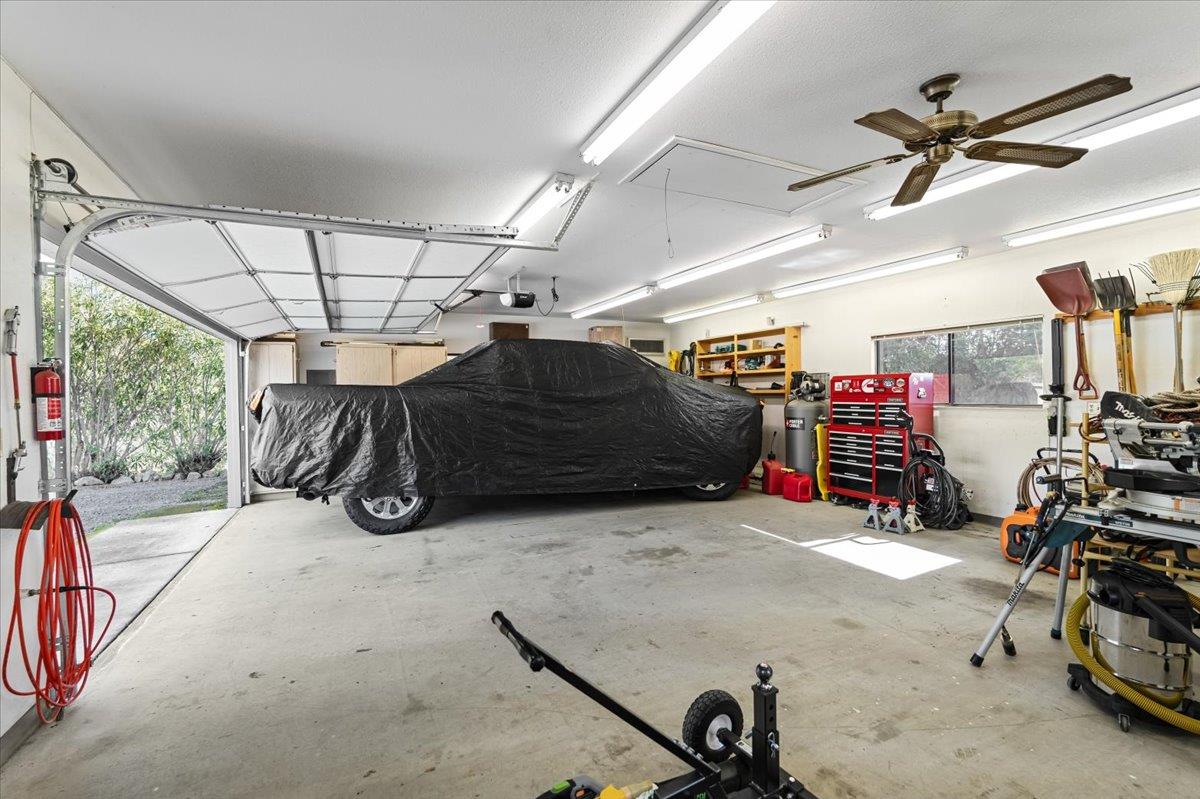 15666 Wolf Mountain Road Grass Valley, CA 95949 - Photo 43 of 78 a view of a garage with a bike and car