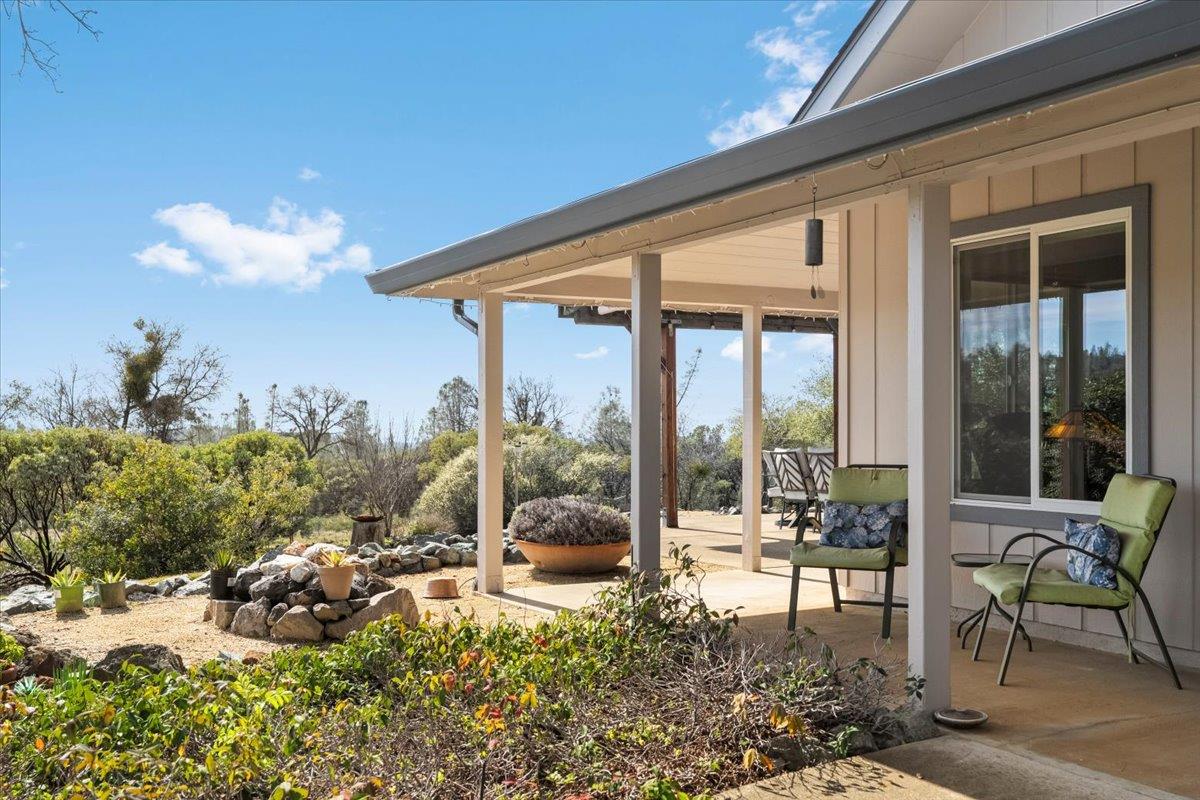 15666 Wolf Mountain Road Grass Valley, CA 95949 - Photo 9 of 78 a living room filled with furniture and a floor to ceiling window