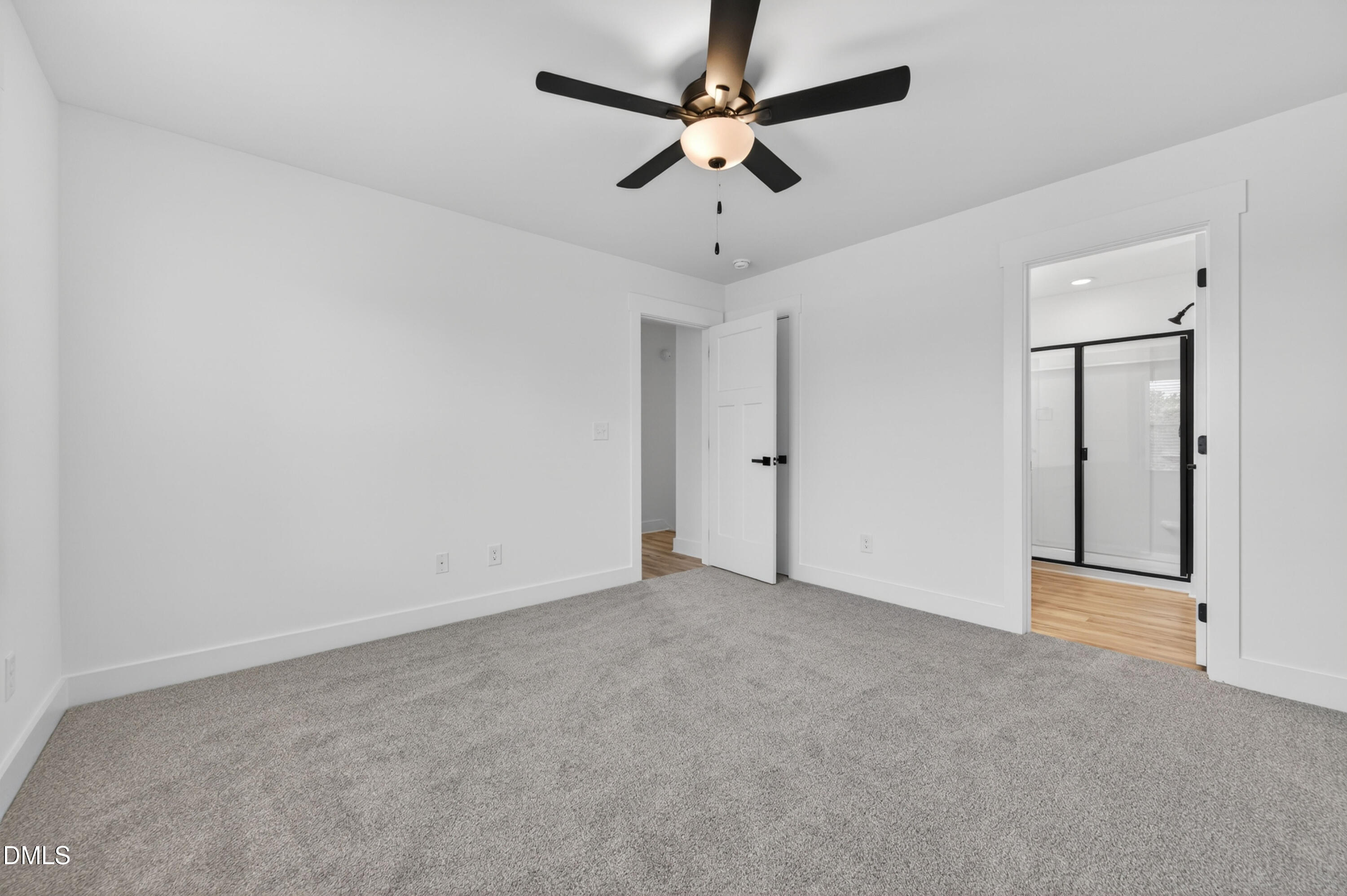 1182 Hurdle Mills Road Roxboro, NC 27573 - Photo 26 of 45 an empty room with a ceiling fan and carpet