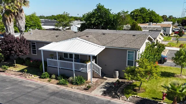 a aerial view of a house with a yard and potted plants