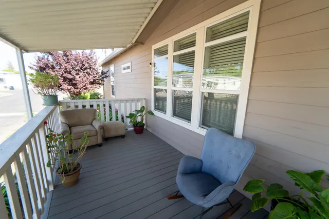 a balcony with furniture and wooden floor