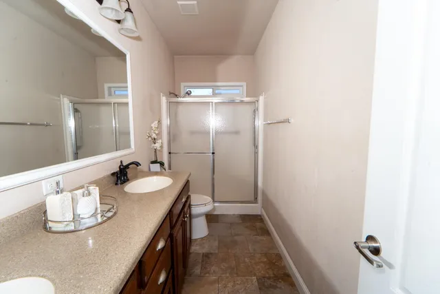 a bathroom with a sink a mirror and shower