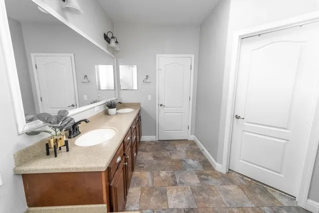 a bathroom with a sink double vanity and a mirror