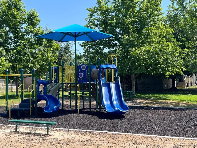 a view of a backyard with a table and chairs