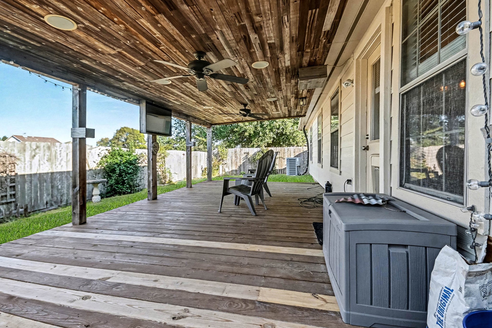 1318 Stevens Court Rosenberg, TX 77471 - Photo 27 of 32 a view of patio with table and chairs and floor to ceiling window with wooden fence