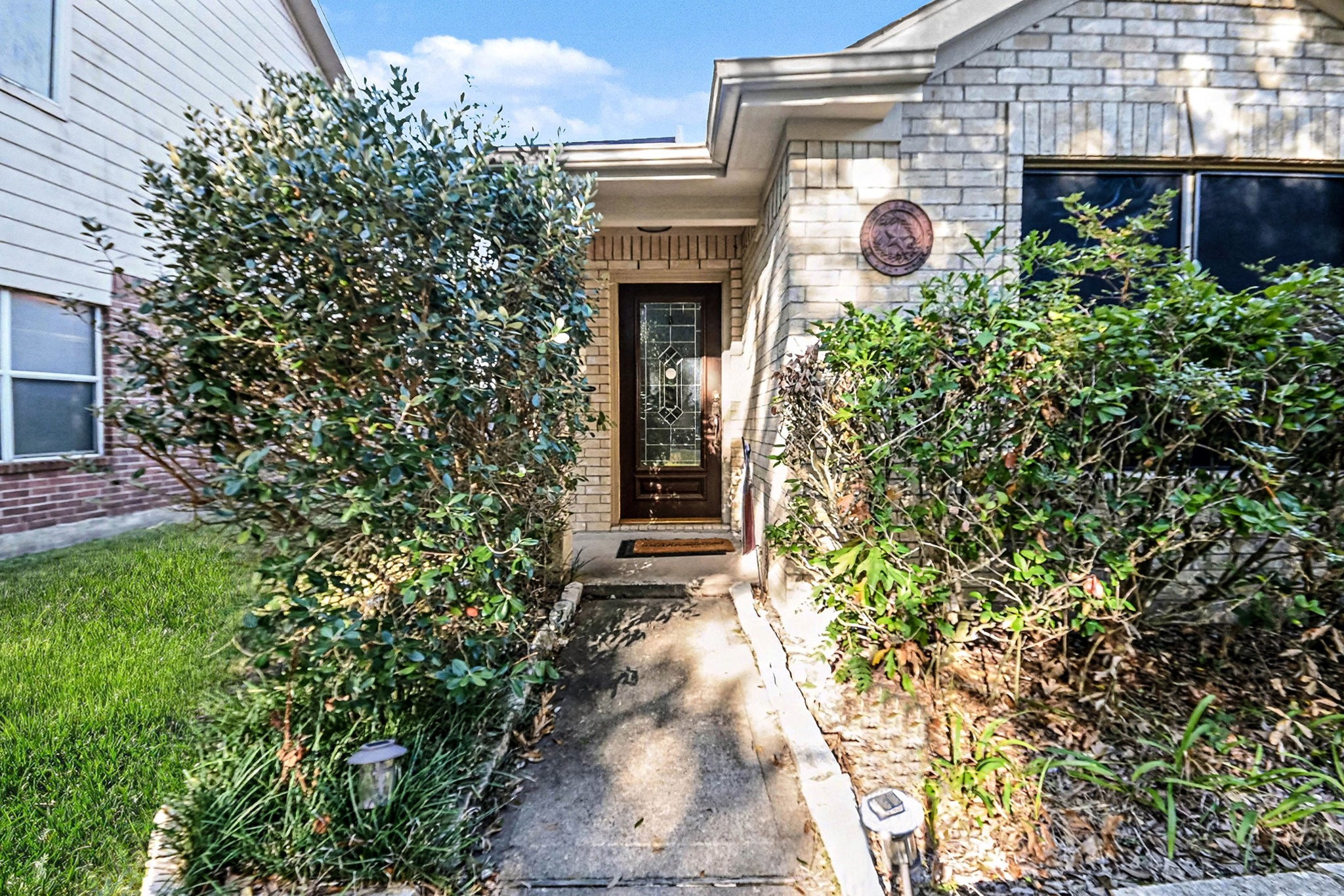 1318 Stevens Court Rosenberg, TX 77471 - Photo 5 of 32 a view of a house with potted plants and a tree