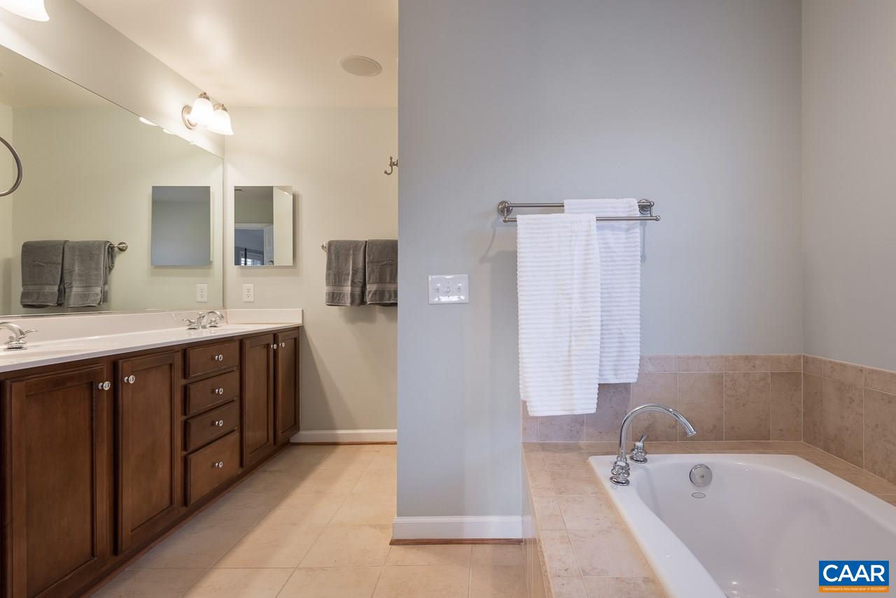 806 Village Road Charlottesville, VA 22903 - Photo 14 of 20 a spacious bathroom with a tub sink shower and mirror