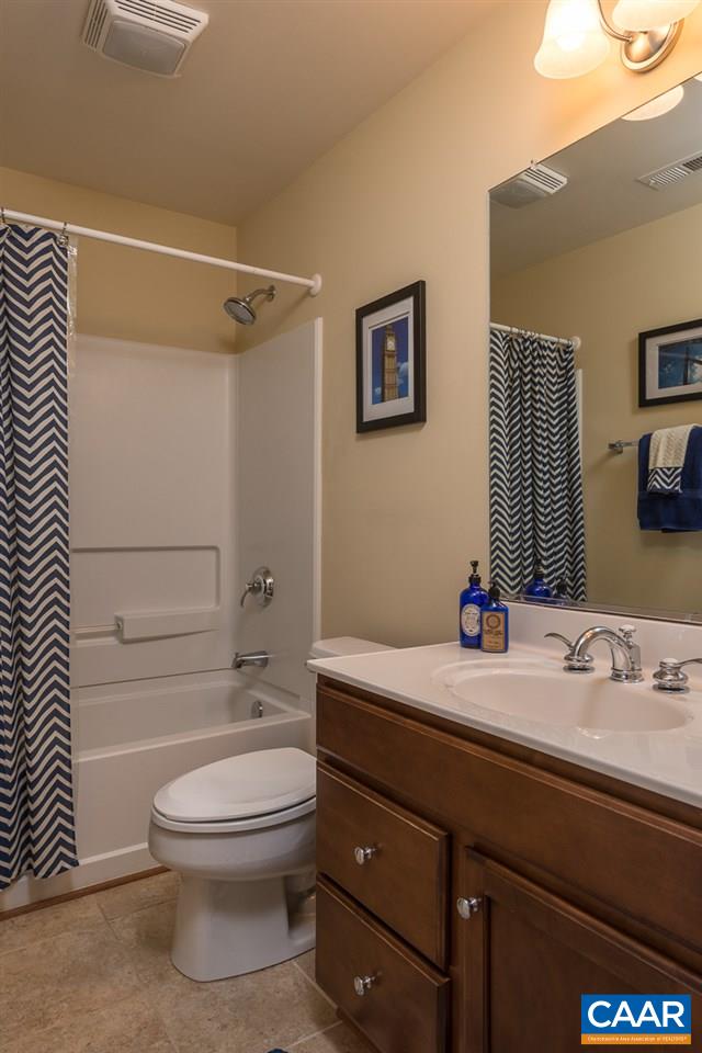 806 Village Road Charlottesville, VA 22903 - Photo 17 of 20 a bathroom with a sink a toilet and shower