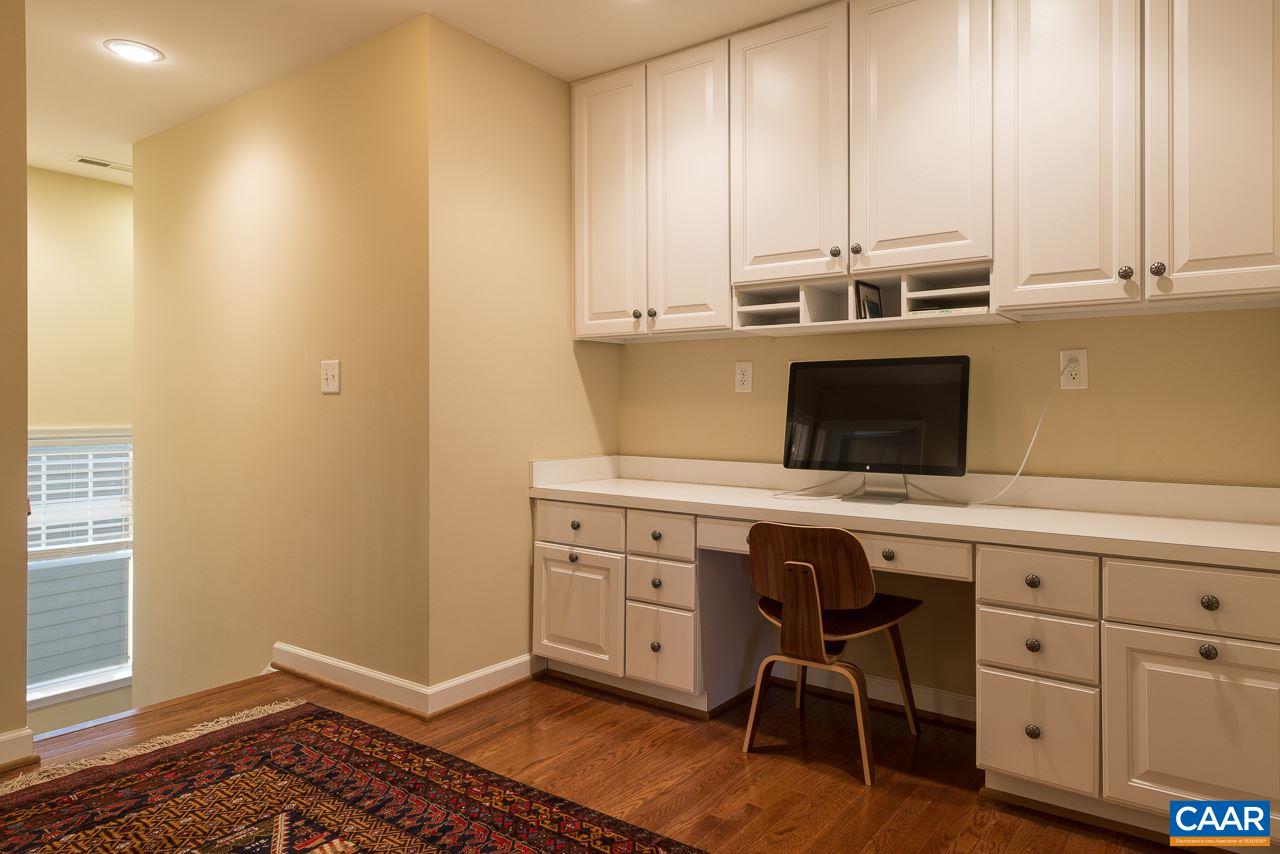 806 Village Road Charlottesville, VA 22903 - Photo 19 of 20 a kitchen with stainless steel appliances a stove a sink and white cabinets with wooden floor