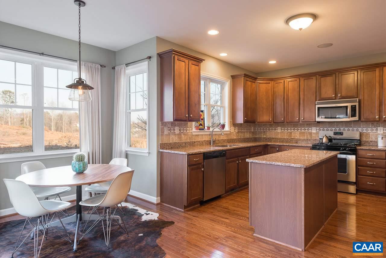 806 Village Road Charlottesville, VA 22903 - Photo 8 of 20 a kitchen with stainless steel appliances granite countertop wooden cabinets a table and chairs
