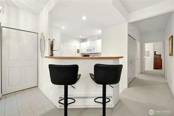 a kitchen with stainless steel appliances granite countertop a counter space and a refrigerator