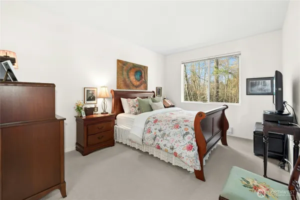 a bedroom with a bed couch and a window