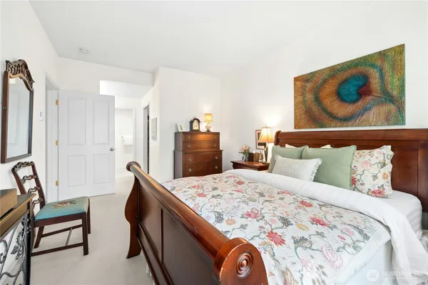 a bedroom with a bed and a painting on the wall