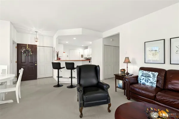 a living room with furniture and a dining table with kitchen view